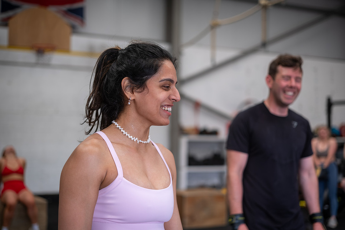 Two CrossFit Bodmin members laughing mid-session